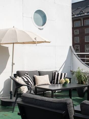 The rooftop terrace invites relaxed moments above the river.