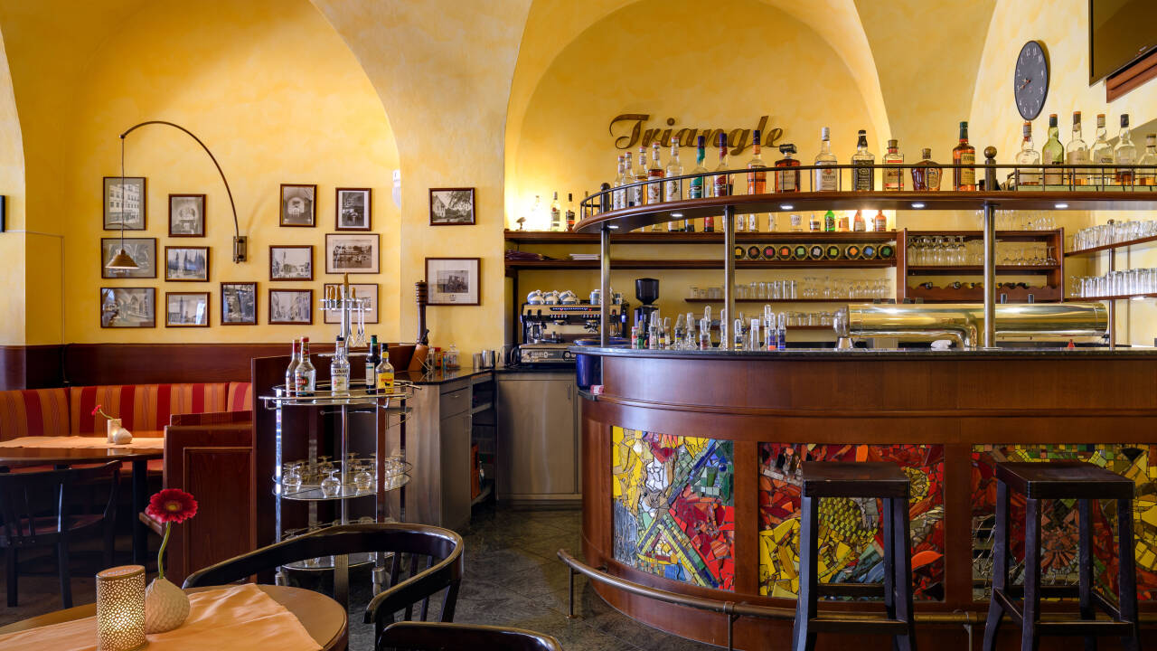 The inviting bar serves drinks and light snacks, perfect for relaxing evenings.