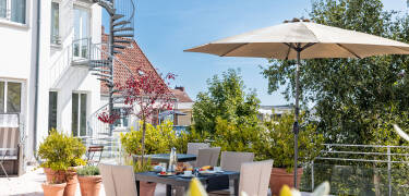 The hotel's sunny courtyard invites you to relax with a refreshing drink.