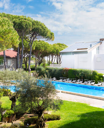 Relax by two pools, surrounded by lush gardens and maritime pines.