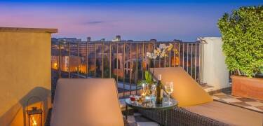 Unwind with a cocktail on the rooftop bar overlooking the city skyline.