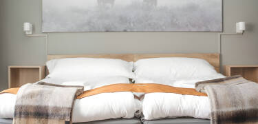 Simple Scandinavian-style rooms offer calm and practical comfort.