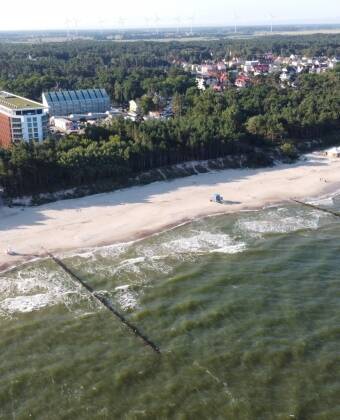 PINEA Resort boasts an excellent location, just steps away from a wide, sandy beach.