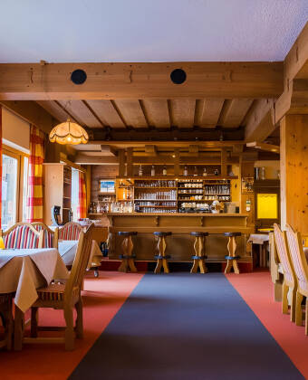The interior features a classic Tyrolean style with warm wood and traditional details.