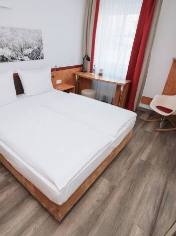 The modern rooms offer comfortable spaces with practical amenities for a relaxed stay.