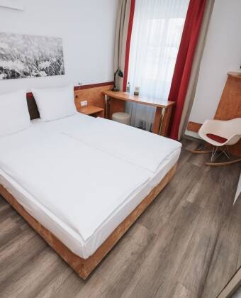 The modern rooms offer comfortable spaces with practical amenities for a relaxed stay.