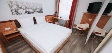 The modern rooms offer comfortable spaces with practical amenities for a relaxed stay.