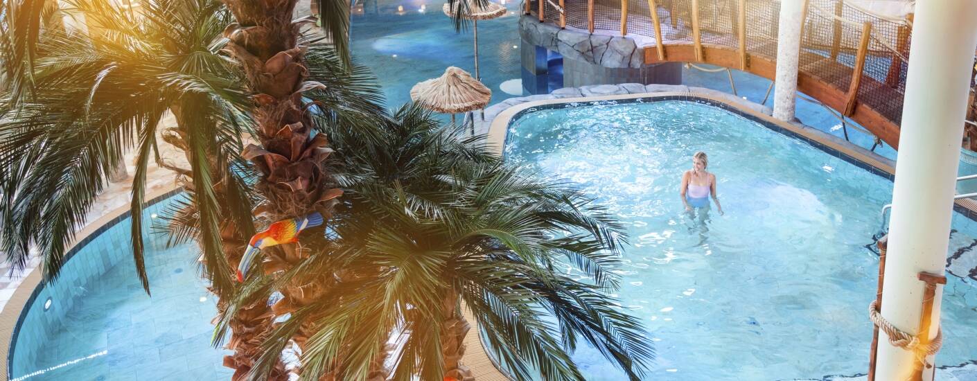 A covered walkway connects the hotel directly to HolstenTherme, placing thermal pools and themed saunas just moments away.
