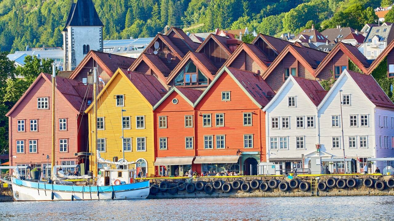 Visit Bryggen, Bergen’s historic harbor district, famous for its colorful wooden warehouses and narrow lanes.