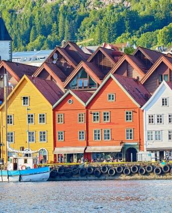Visit Bryggen, Bergen’s historic harbor district, famous for its colorful wooden warehouses and narrow lanes.