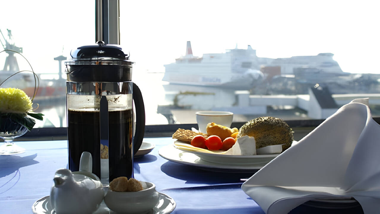 Nyt frokosten med en fantastisk utsikt til byens pulserende havn fra hotellets 6. etasje.