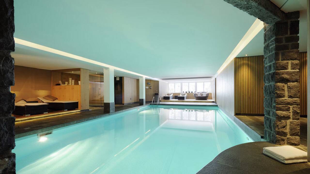At First Mountain Hotel, unwind in a generous spa area with pool, saunas, and inviting relaxation spaces.