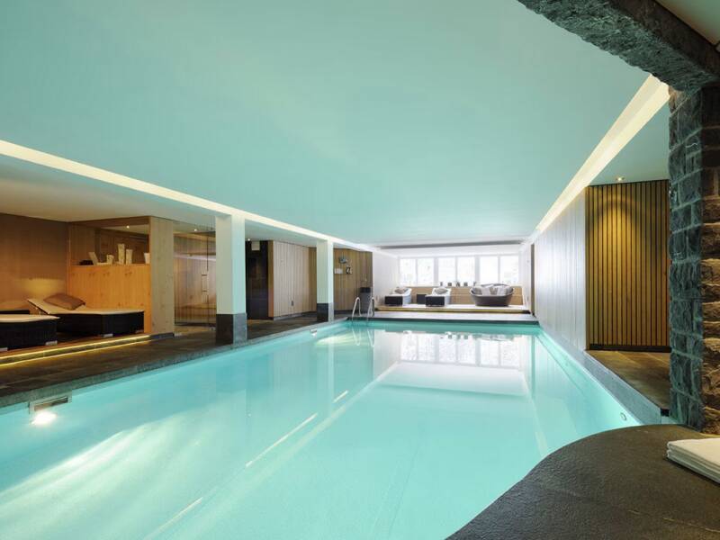 At First Mountain Hotel, unwind in a generous spa area with pool, saunas, and inviting relaxation spaces.