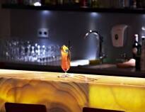 You will be welcomed with a delicious cocktail at the cosy bar.