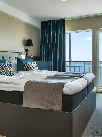 Treat yourself a little extra and upgrade to a room with a balcony and a splendid view of the fjord.