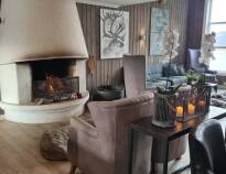 A fire in the fireplace and many candles create a cosy atmosphere in the hotel.
