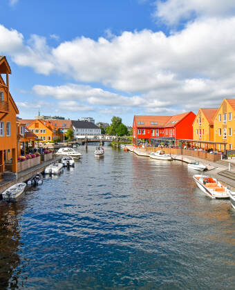 Experience Fiskebrygga, Kristiansand’s iconic waterfront with its colourful buildings and lively harbour atmosphere.