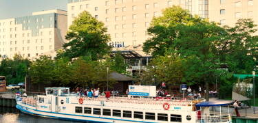 Vor dem Hotel kann man das schöne Wetter im Sommergarten am Wasser genießen.
