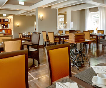 Genießen Sie Ihr Frühstück im mit antiken Möbeln eingerichteten Hotelrestaurant.