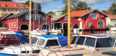 Oplev det livlige havnemiljø med både, udsigt over vandet og ægte kyststemning.