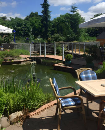 Unwind on the sunny terrace or stroll by the garden pond.