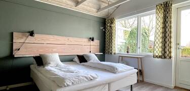 Stay in a lovely room of Kirsebærkroen, a quiet retreat in the stunning nature of South Zealand.