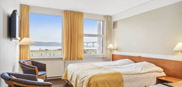 Book a comfortable room with an amazing view of the fjord.