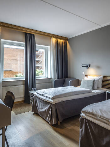 Die gut durchdachten Gästezimmer verfügen über bequeme Betten und praktische Details für erholsame Nächte.
