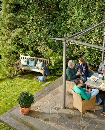 Enjoy a cold glass of white wine in good company in the hotel's cosy garden