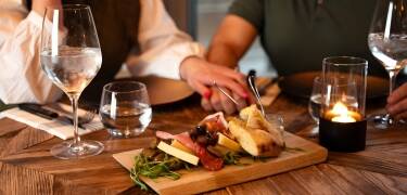 Freuen Sie sich auf ein köstliches Abendessen, das entweder aus einem vom Küchenchef ausgewählten Hauptgang der Saison oder einem Tapas-Teller besteht.
