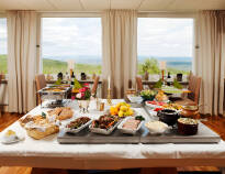 Dine in the hotel's bright restaurant with a beautiful view of the countryside outside