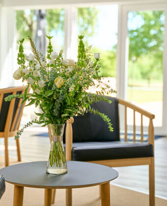 The hotel is located in peaceful, green surroundings, perfect for relaxation and outdoor activities.