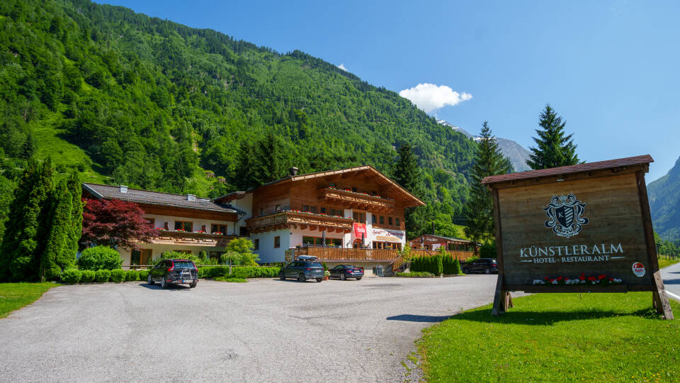 The hotel features an Alpine architectural style in a calm Austrian setting.
