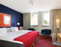 The hotel's modern rooms are equipped with comfortable beds to ensure a good night's sleep.