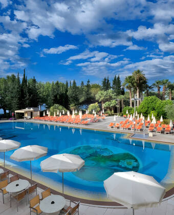 The hotel has an inviting outdoor swimming pool with sun loungers and parasols