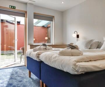 Genießen Sie Zimmer im nordischen Lichtstil mit einzigartigen historischen Akzenten, die das lokale Erbe widerspiegeln.