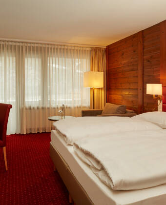 Relax in Swiss-style rooms with balconies and panoramic mountain views.