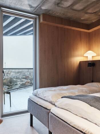 Enjoy sleek, raw interiors paired with private balconies in every room, offering lovely sea or city views.