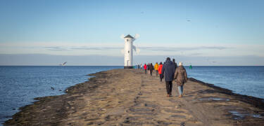 One of Swinoujscie's most popular attractions is the Mühlenbake, a white landmark on the western pier that has been signaling the entrance to the Swine to incoming ships since 1873.