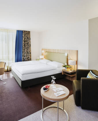 Genießen Sie geräumige Zimmer mit eleganter Einrichtung und komfortablen Queen- oder King-Size-Betten.