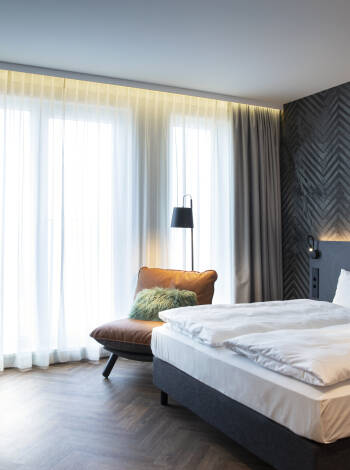 Book a lovely room with a modern design and smart amenities for a relaxing stay.
