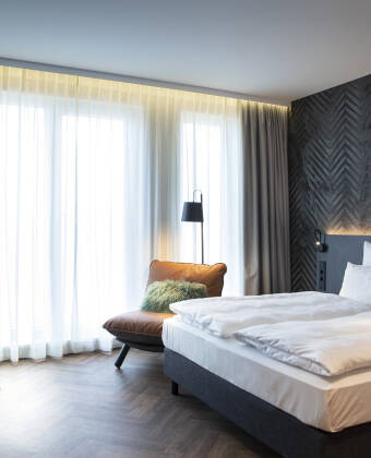 Book a lovely room with a modern design and smart amenities for a relaxing stay.