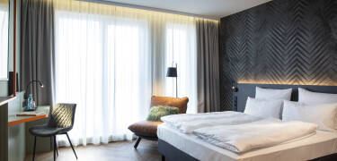 Book a lovely room with a modern design and smart amenities for a relaxing stay.
