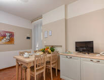 The apartments are equipped with bathrooms, beds and a small kitchen with a dining table.