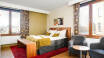 Hotellets hyggelige værelser er indrettede i lyse farver og masser af charme.