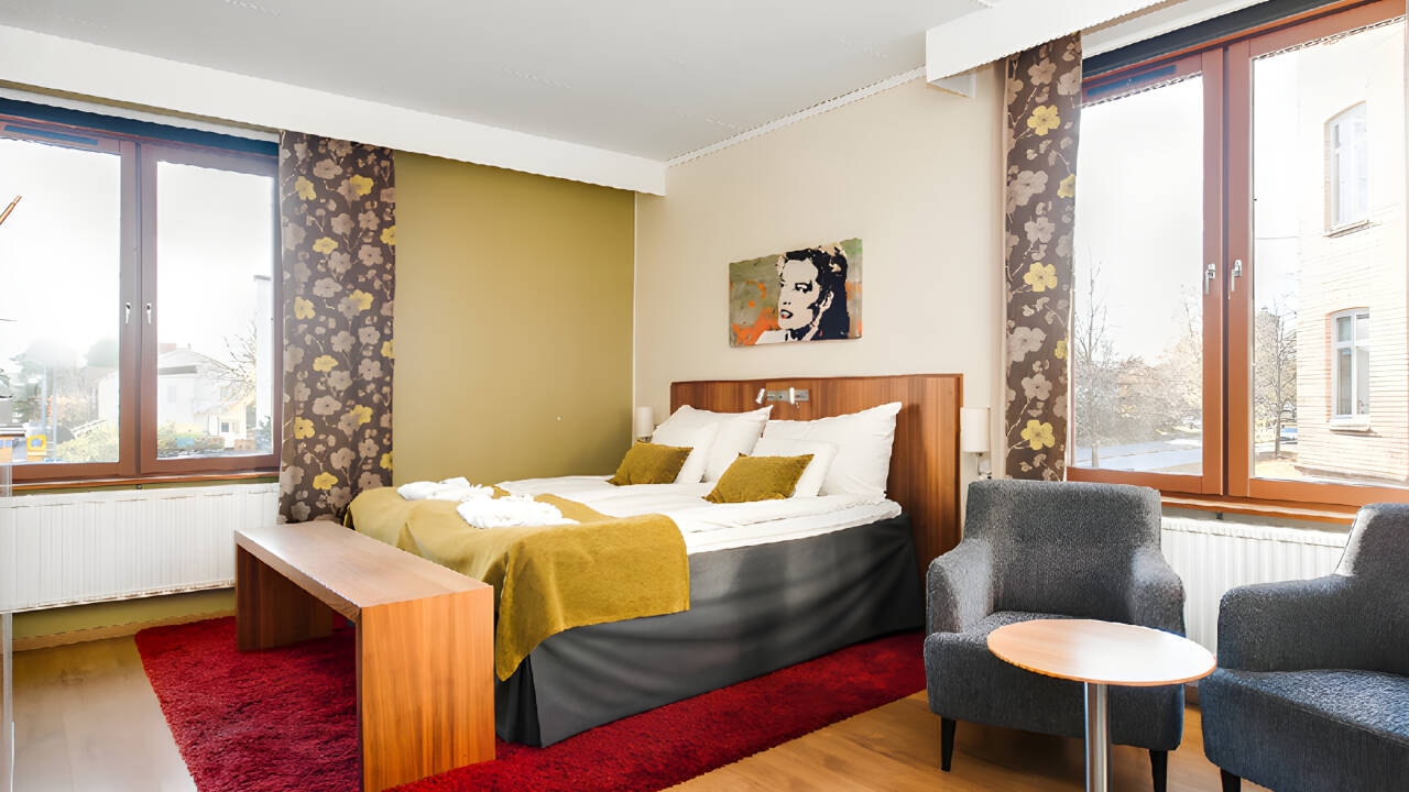 Hotellets hyggelige værelser er indrettede i lyse farver og masser af charme.